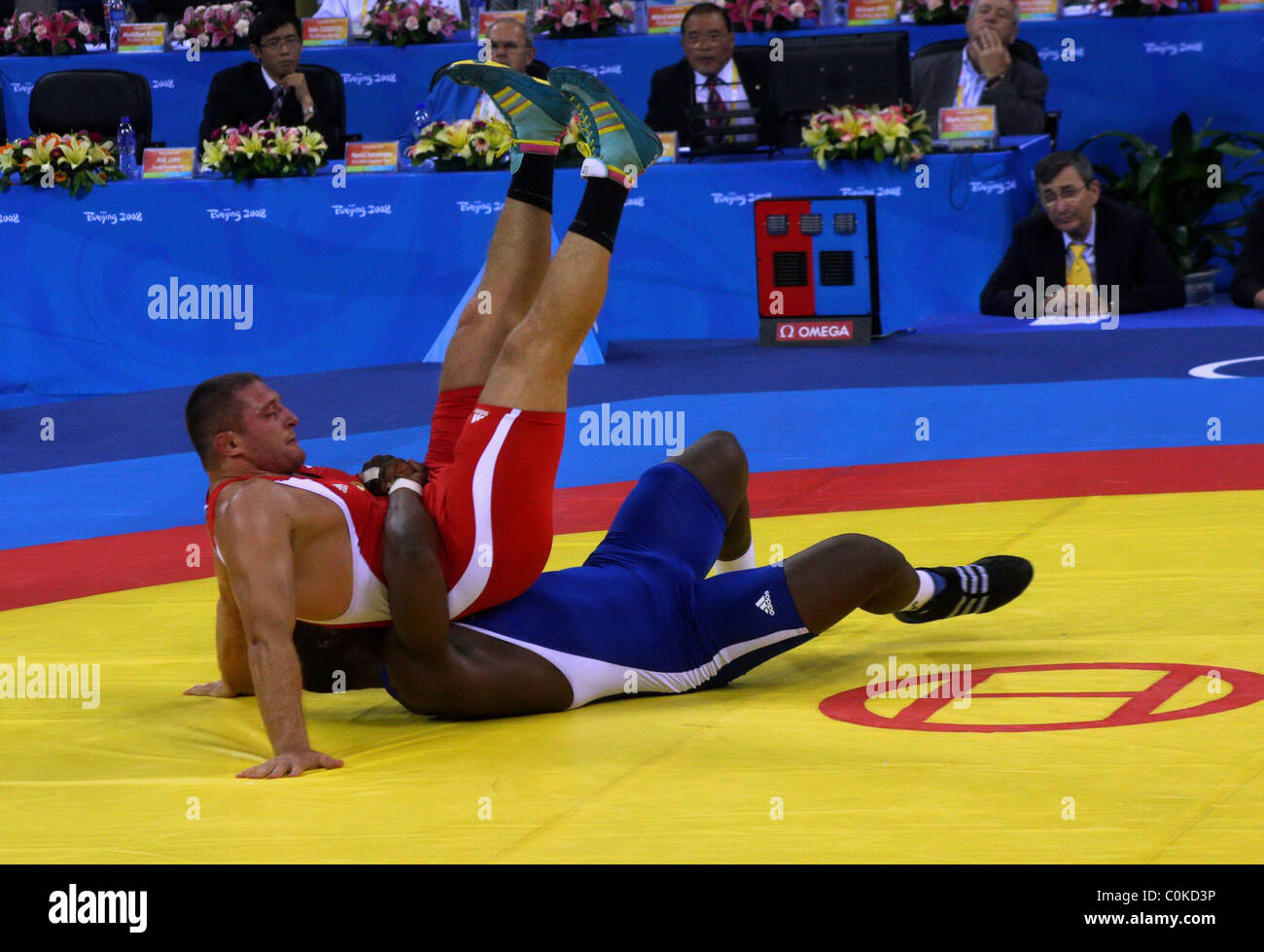 Mijain Lopez (blue) wrestles with Khasan Baroev(red). Cuba`s Mijain